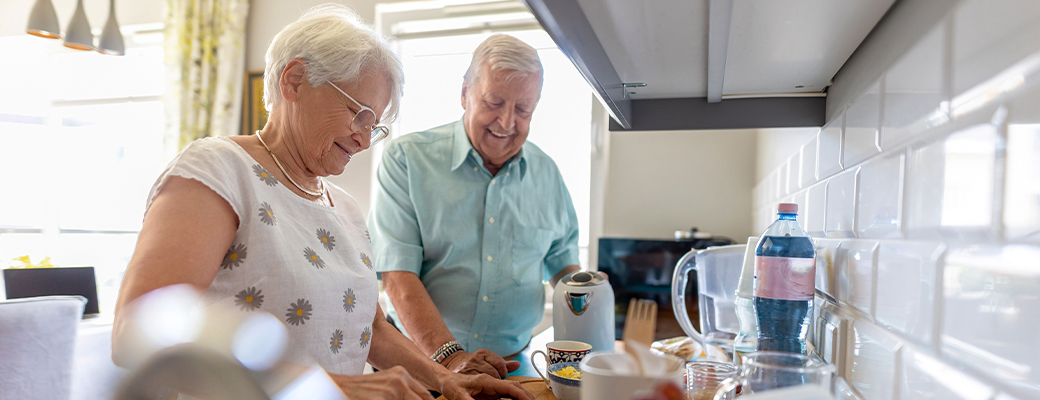 Image of senior man and woman working in the kitchen together